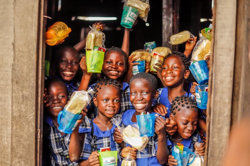 Children smiling with treats and snacks